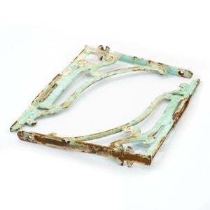 this is a side angle view of a pair of vintage iron shelf brackets