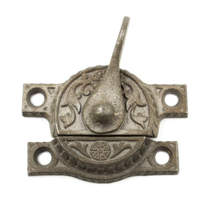 this is a bird's eye view of an antique victorian sash lock that shows the floral pattern on the top