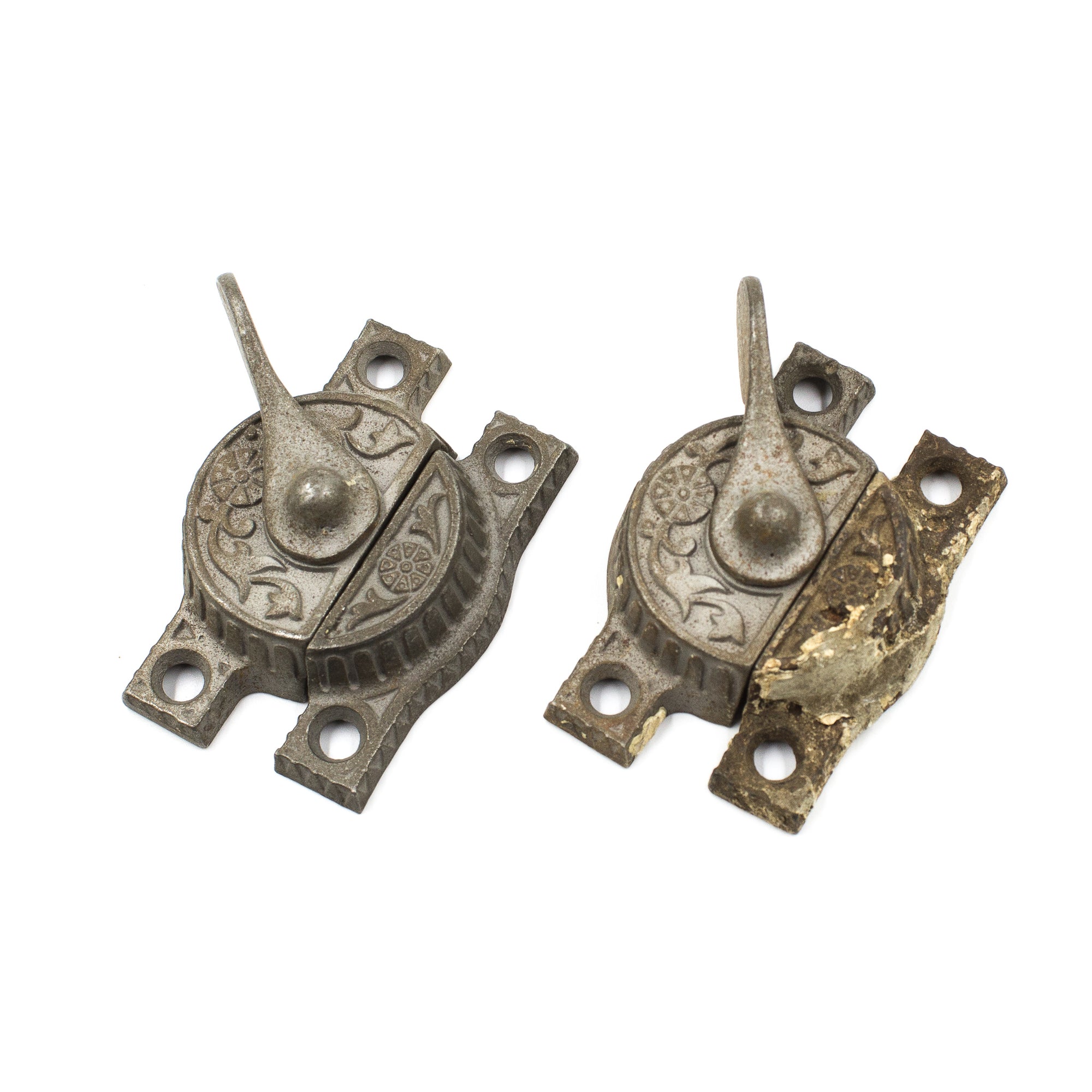 this is a pair of two antique victorian sash locks, one of them has some old paint and rust on it