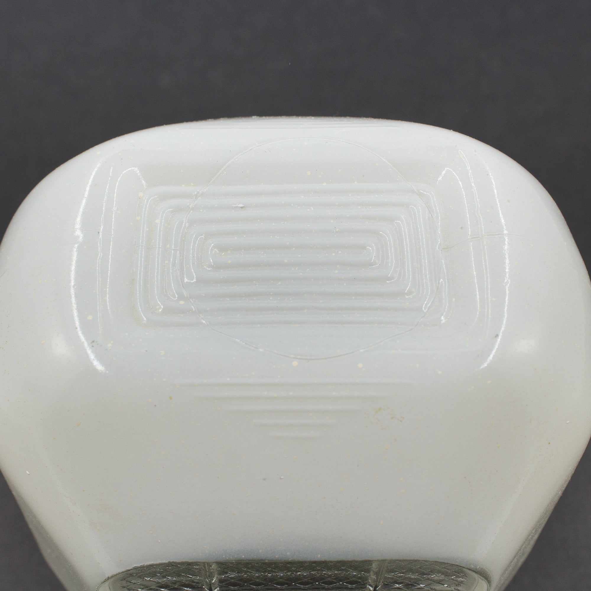 this is a vintage mid century white glass sconce shade with a grid pattern on the front