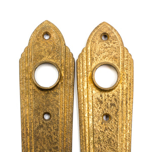 this is a picture of a pair of vintage art deco rose brass escutcheons showing the top halves where the doorknobs would go 