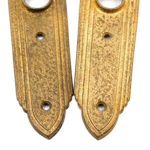 this is a picture of a pair of vintage art deco rose brass escutcheons showing the bottom halves 