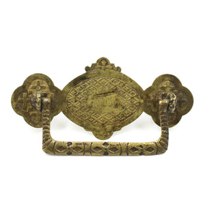 this is an antique vintage brass ornately designed bail pull