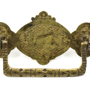 this is a picture showing the detail on an antique brass bail pull