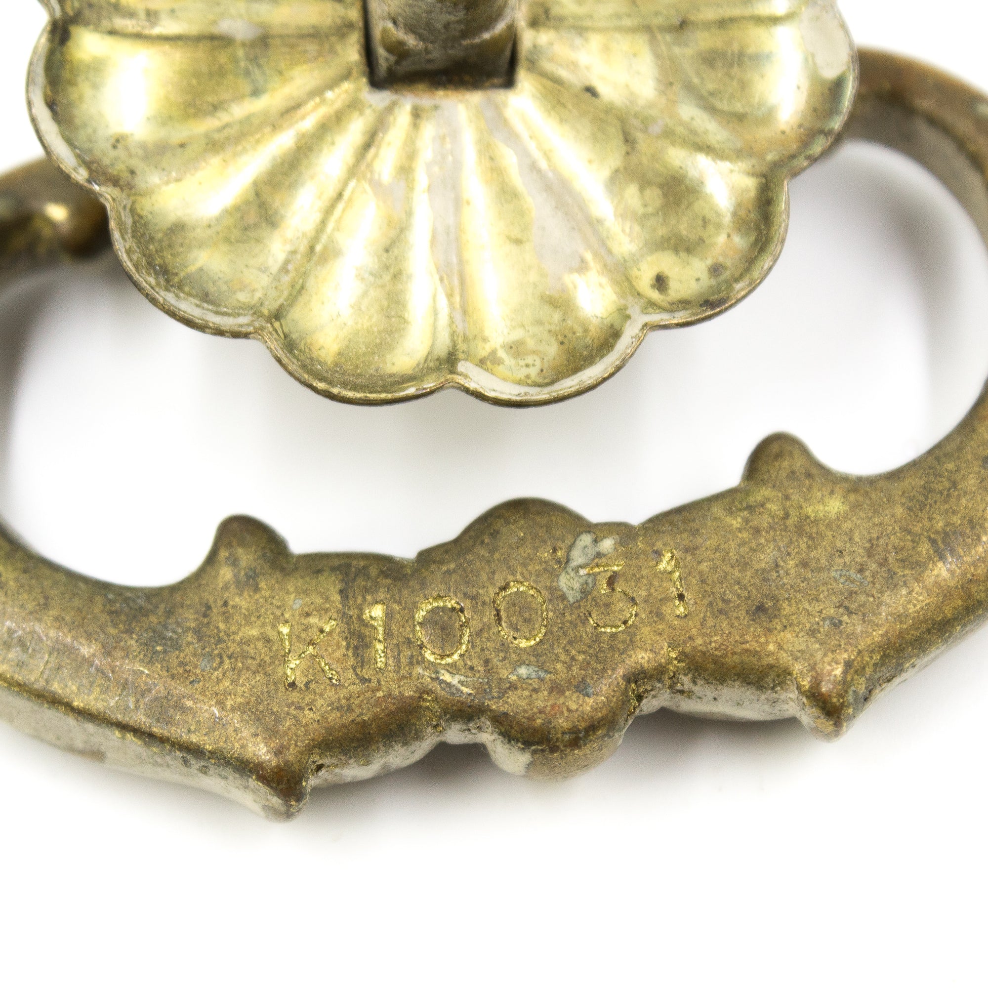 this is a picture of an antique bronze ring pull showing the back with the patent numbers