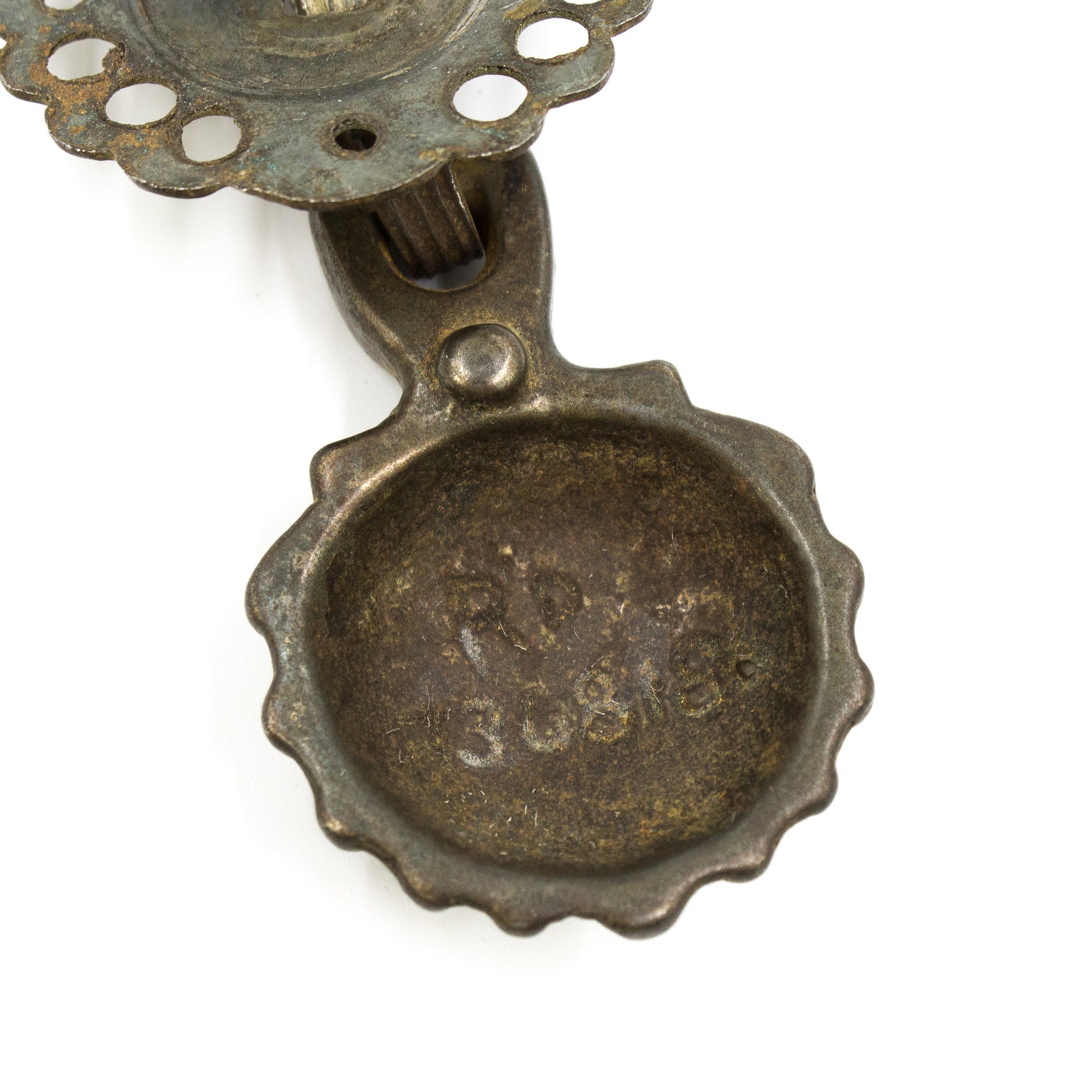 this is a picture of the back of the drop on an antique drop pull. There are letters and numbers on it and they are hard to see, it most likely says RD 30818