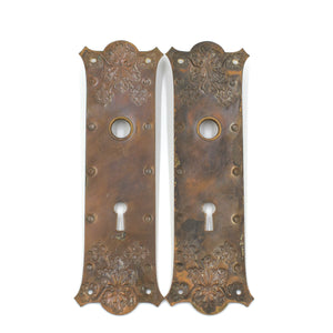 this is a picture of the backs of a pair of two vintage victorian floral copper escutcheons