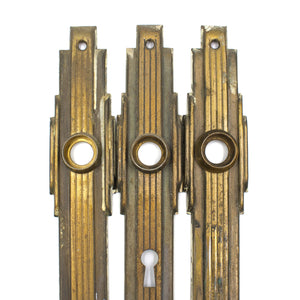 this is a close up picture of a set of three vintage mid century art deco escutcheons showing the top parts of each of them