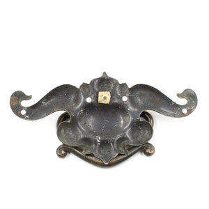 this is the backside of a vintage art nouveau drawer bail pull