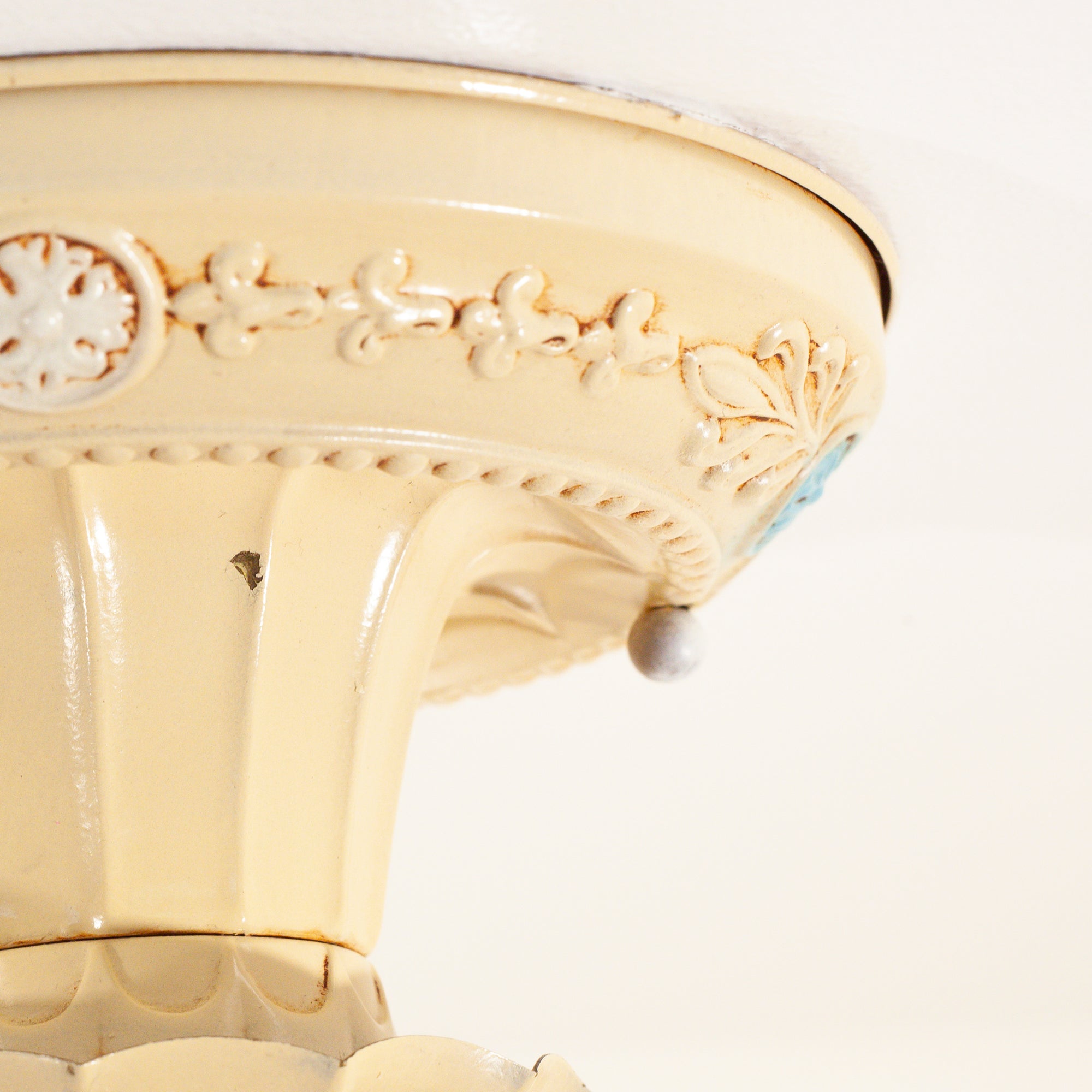 this picture shows the detail and design on the canopy of a vintage bare bulb ceiling fixture