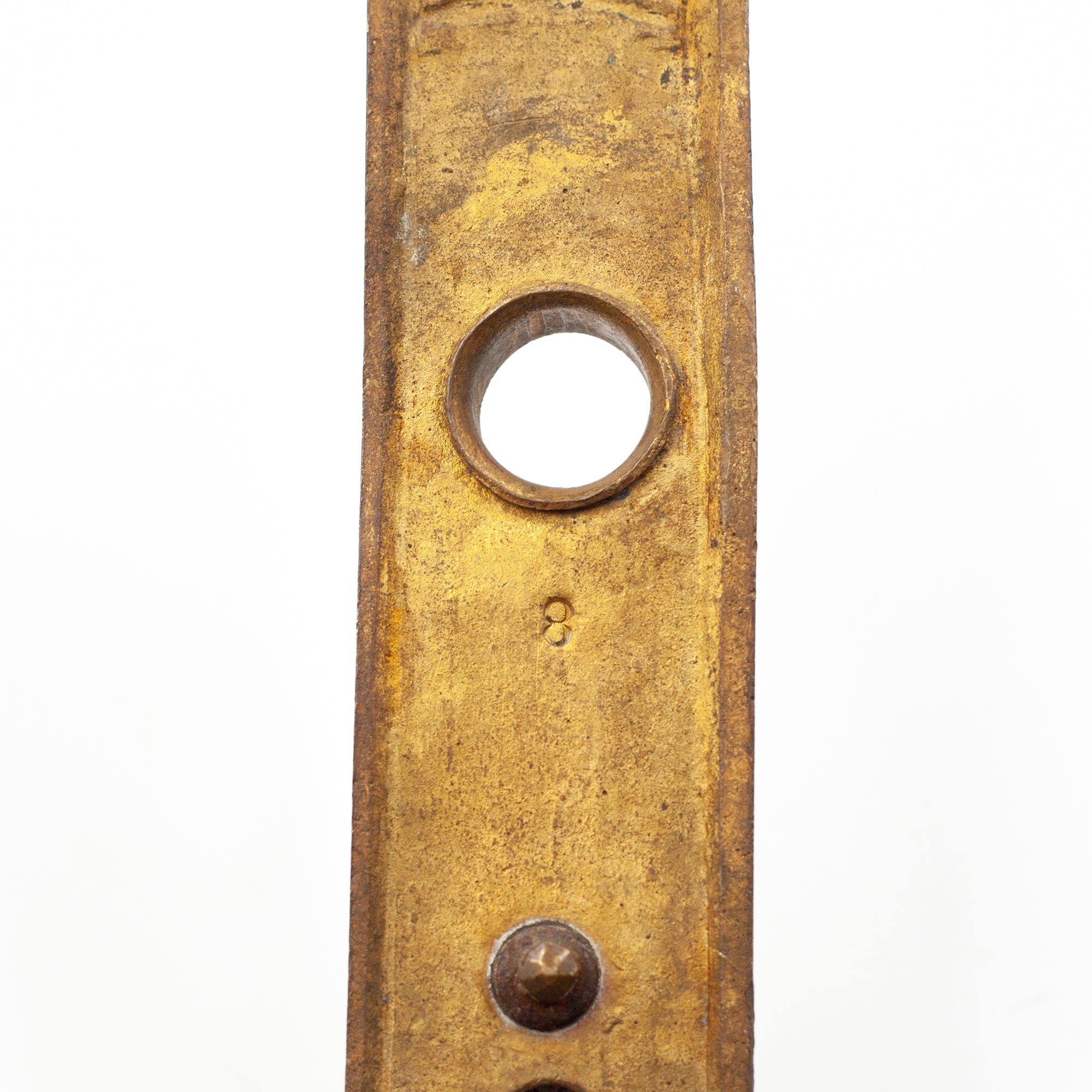 this picture shows the number 8 stamped into the back of a vintage brass escutcheon