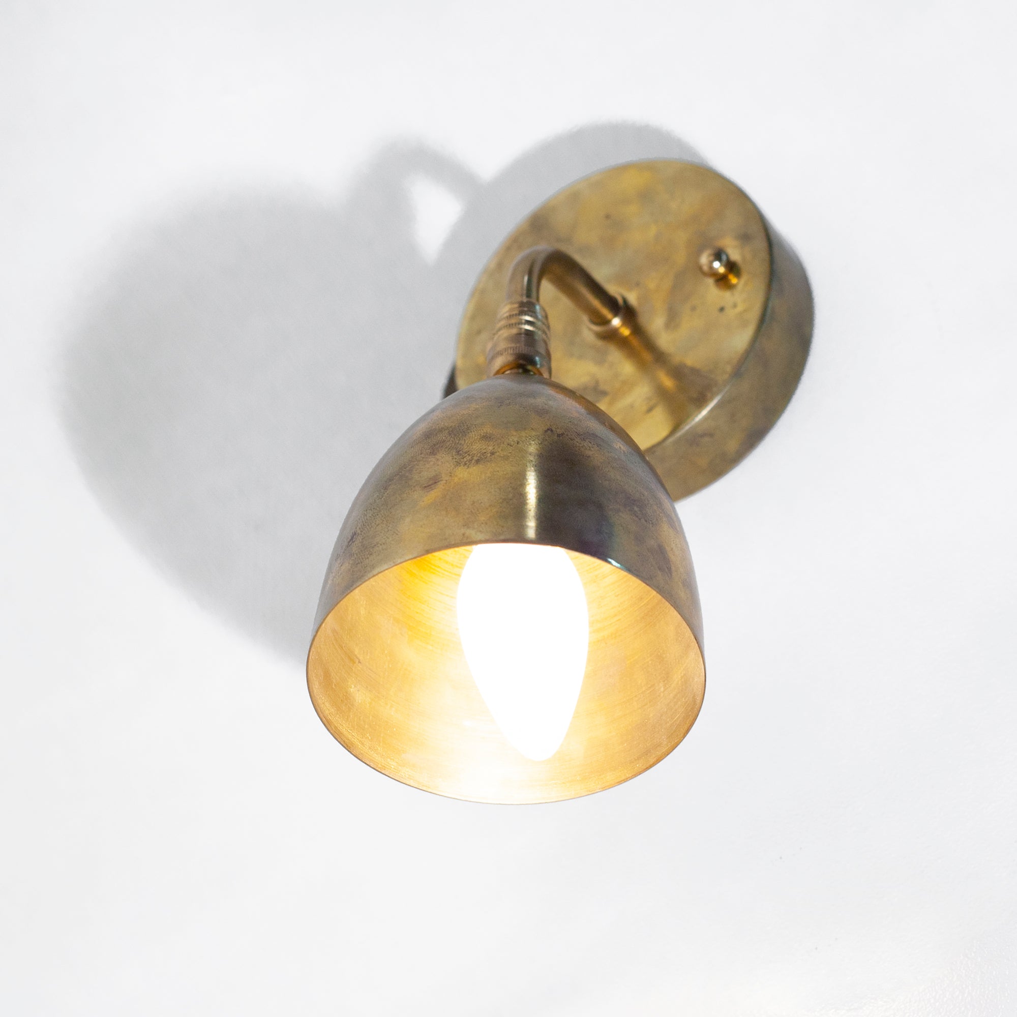 this is an antique brass wall sconce